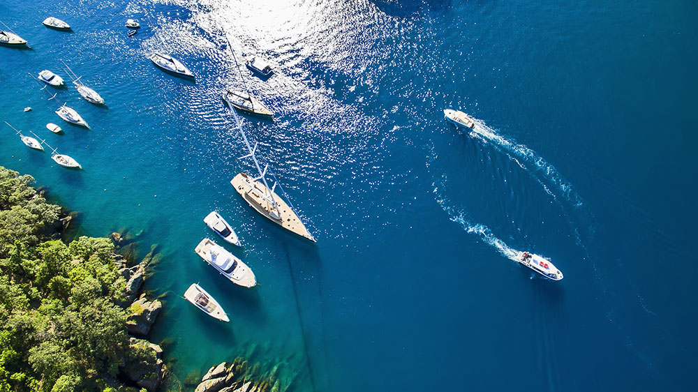 Sea with moving boats in the Portofino Natural Park