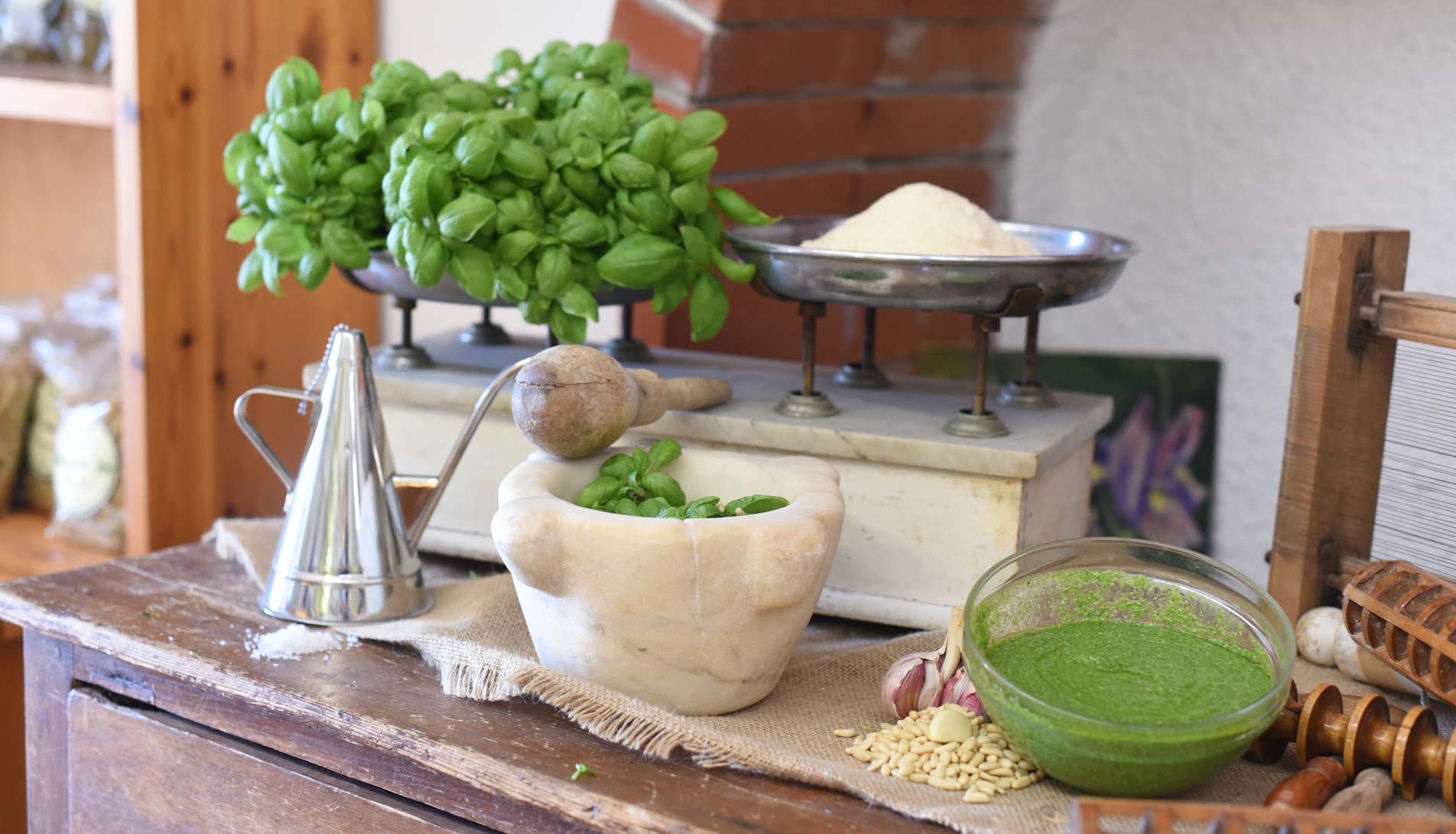 table with pesto, mortar and basil